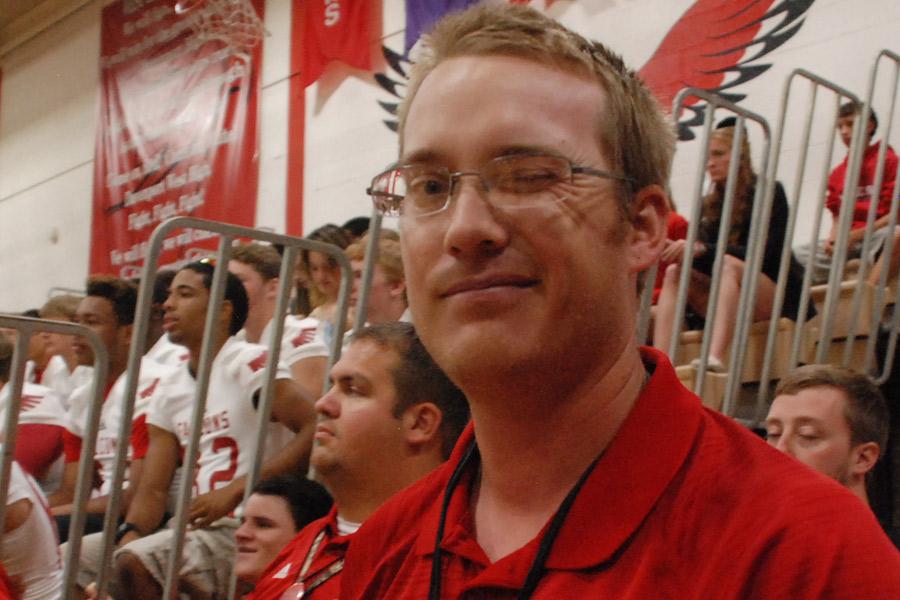 After leading the school in a cheer, football coach Justin Peters winks at the photographer during the pep assembly Aug. 28.