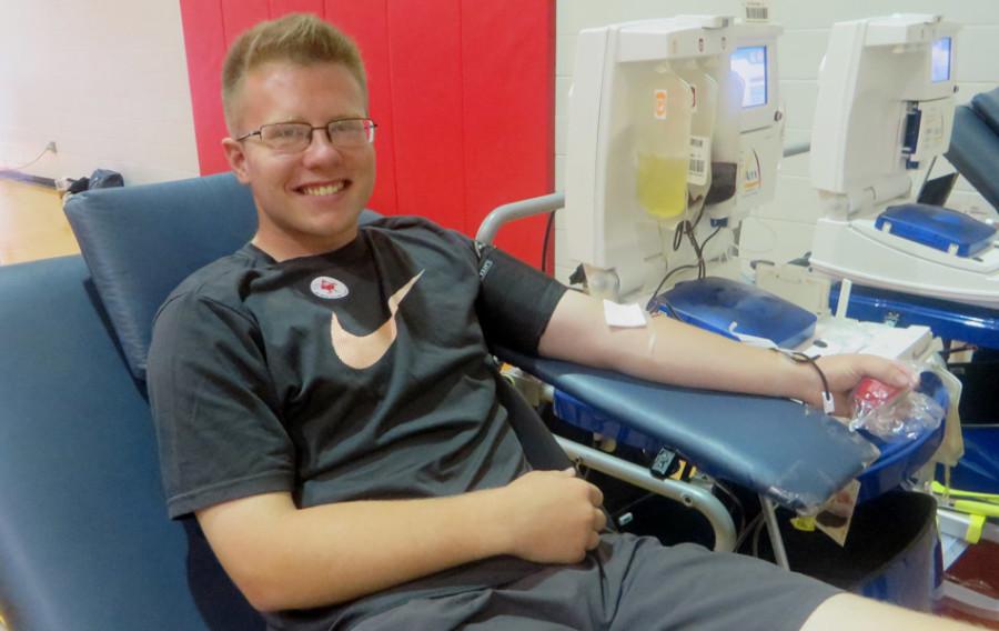 Senior Logan McBee donates a double unit (two pints) of blood for his second time to become a gallon donor at the West High Student Blood Drive on Sept. 10 in the West Family Y gym.