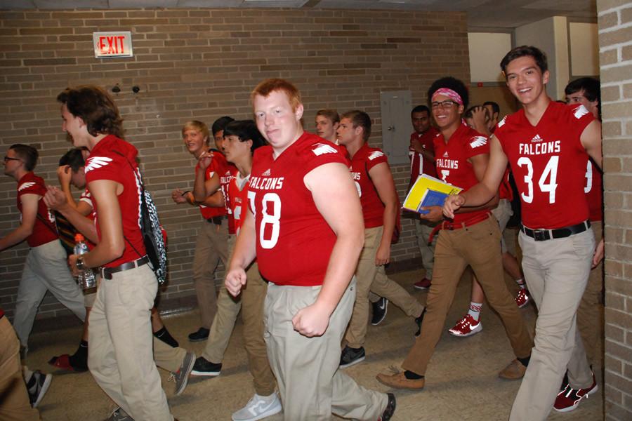 Hayden Heath walks with his teammates in a surprise parade down the halls during Block 4 on Sept. 4.
