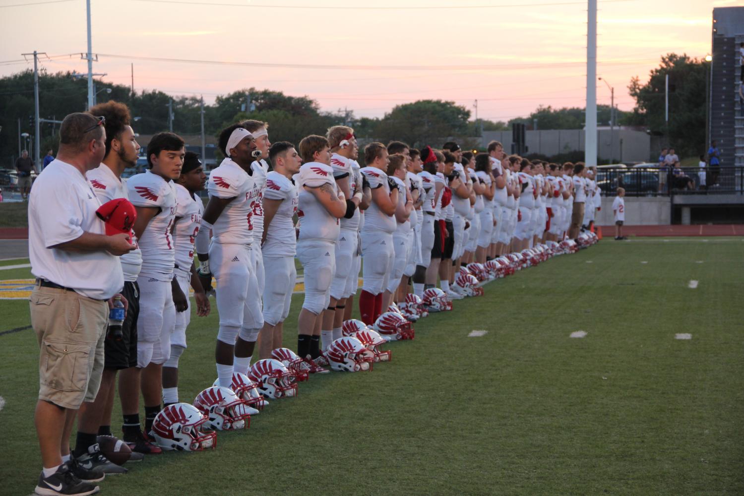 The varsity team lines during the national anthem. 