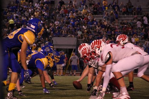 The Falcons and the Wildcats face off in pre-snap formation.