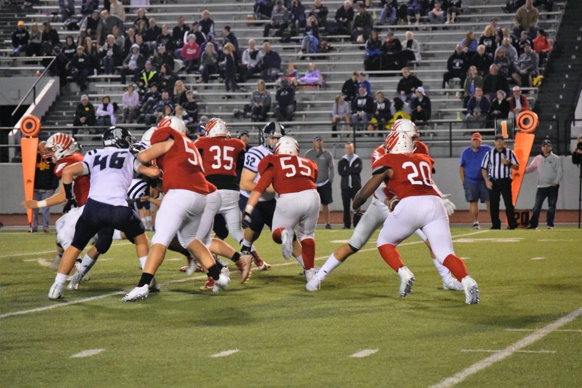 Varsity defense attempts to block PV.