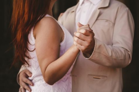 A couple enjoys last slow dance of the night.