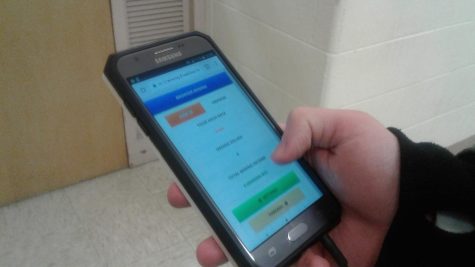 Junior Devin Shelsky uses his phone to sign onto his Bitcoin account.