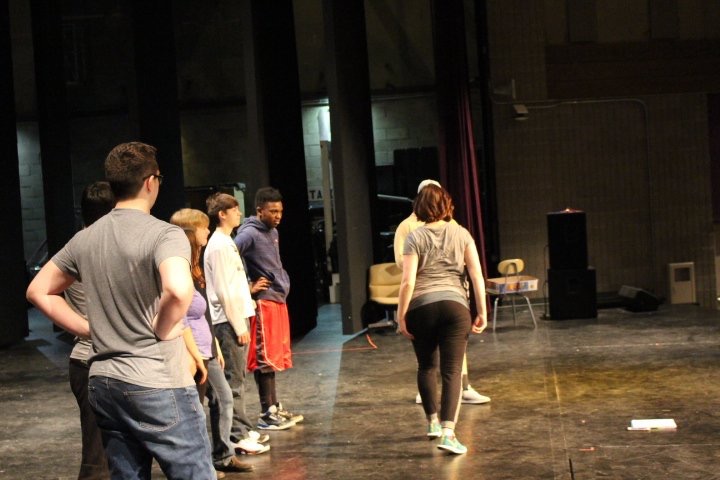 Choreographer Steph Delacy teaching the cast of Oklahoma! the choreography to a dance.