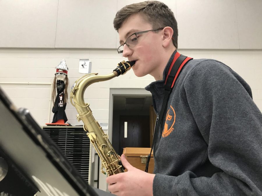 Senior William Zogg plays the saxophone, practiced hands flying across the keys of the instrument with style.