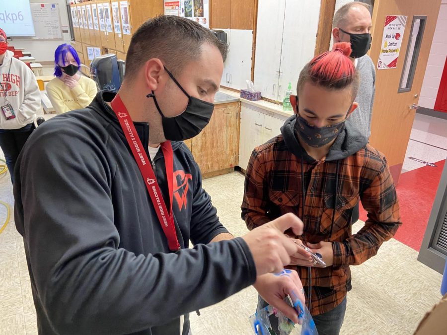  Mr. Schaeffer helps Jaden Nguyen 22 with airbrushing. Airbrushing is used to give an even surface when painting. Its usually used to create realism.
