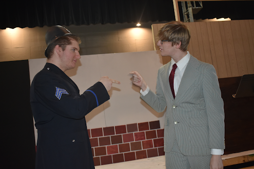A policeman, played by David Beitzel ‘23, reprimands Mercury Theater director Orson Welles, played by Nate Gaghagen ‘22, and tells him to stop broadcasting the story since people are getting hurt. Gaghagen’s character refuses, saying that it isn’t Mercury Theater’s fault if the listeners aren’t able to tell the difference between truth and fiction. 
 
