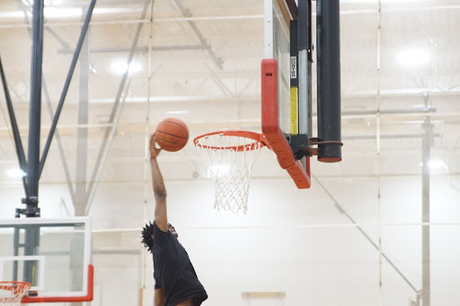 Phearless Caruthers ‘22 shows off his athleticism with a slam dunk during spring basketball practice.
