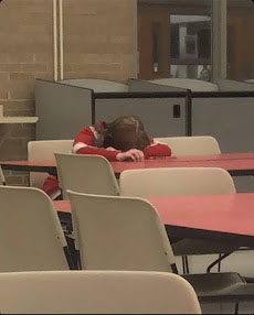 Ava Henson sleeping in the lunchroom. 
