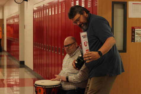Mr. Flaherty and Mr. Baldry sit and play outside of Flaherty’s classroom during the second to third block passing time. “[We] decided to do something goofy that gets people’s attention and bring it to the hunger drive, I guess,” Baldry said.