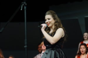 Senior Paige Sinksen sings at the show choir opening night. This is where they got to showcase all their hard work for the fir