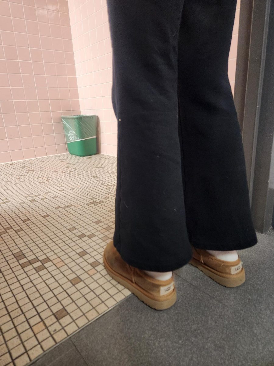 A student walking into one of the most used bathrooms in the school, that is constantly overcrowded with people.